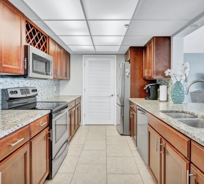 Fully Furnished Kitchen.   Laundry room behind door.