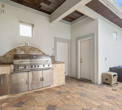 Generously sized gas grill cooking area with full outdoor bathroom