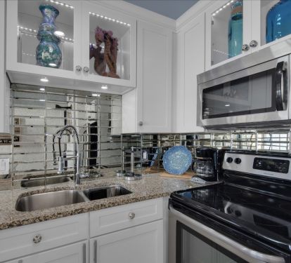 Smoked glass backsplash appointed with color changing LED lights 