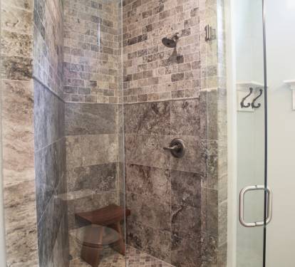 Travertine shower with teak bench