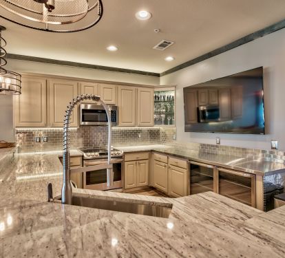 Kitchen w/ 70 inch tv, below counter appliances, zero radius sink and more