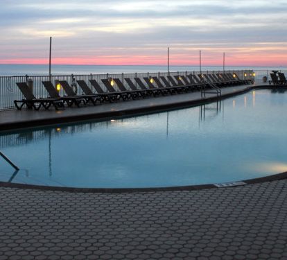 View of our tropical beach front 120 ft heated pool at sunset.