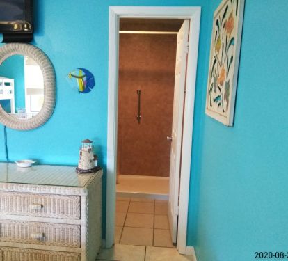 Walk in shower with safety bar.