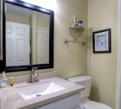 Hall half bath with separate entrance to shower/laundry room