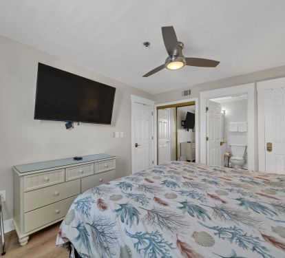 Master bedroom with king bed, smart TV and master bathroom