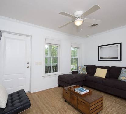 Living area with flat screen TV and ceiling fan