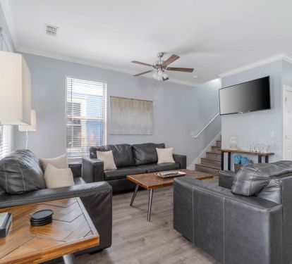 First floor living room with large TV and pull out queen bed