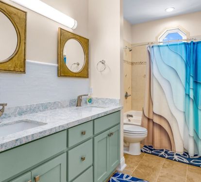 Upstairs hall bath with dual vanity and shower/tub combo