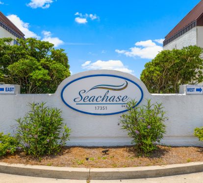 ENTRANCE VIEW SEACHASE SIGN. DRIVE IN BETWEEN EAST AND WEST BUILDINGS  