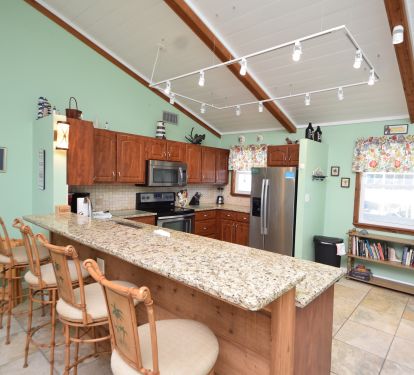 Bar top in the kitchen with barstools and outlets