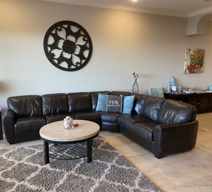 Comfortable leather couch in the living room with ocean views.