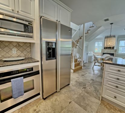 Chef's kitchen with stainless appliances &amp; granite countertops.