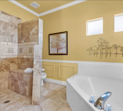 Master bathroom with large soaking tub and spacious shower with bench seat.