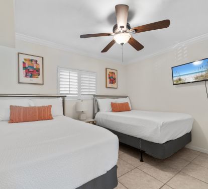 Guest bedroom has two full size beds and flat screen tv.