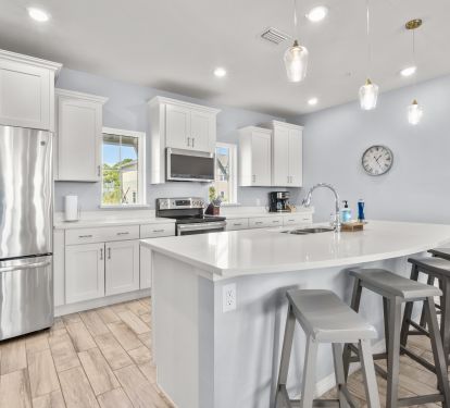 Spacious and fully stocked kitchen with bar seating and coffee center