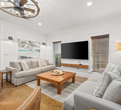 Spacious Living Room complete with massive TV, Fandalier, and swivel rockers.