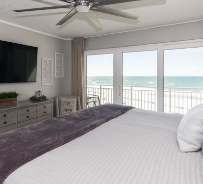 Roomy master bedroom with balcony access and 60" smart tv.