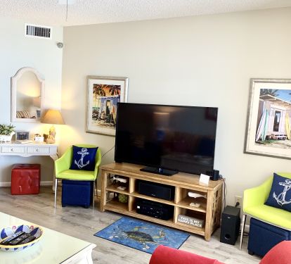 Gulf Front living room with 60in TV and 5.1 surround sound system balcony access
