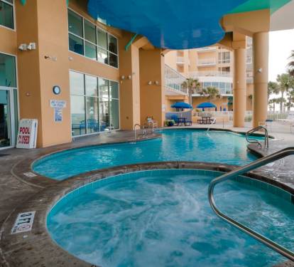 The hot tub is located next to the family pool. Both are near the Splash Pad.