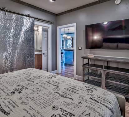 Guest King Bedroom with metal barn door into en suite bathroom