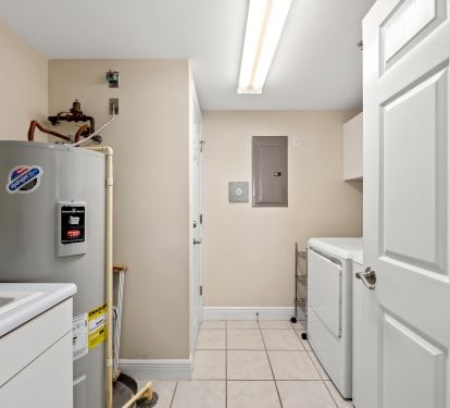 Laundry room with large sink and full size washer and dryer 