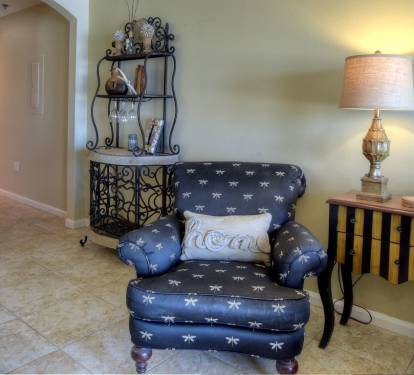 Comfy chair and view of hall to front/entry door