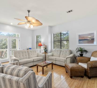 Main living area with ample seating, recliner couches and balcony access