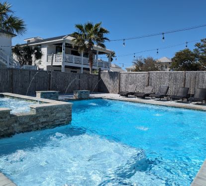 Huge pool &amp; spa with sun shelf, deck jets, waterfalls and lounge chairs