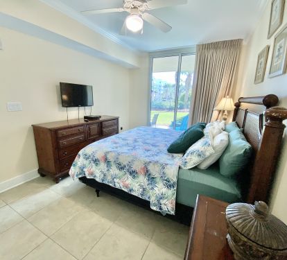 Mater bedroom with king bed and access to the patio.