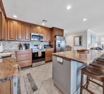 Kitchen, counter, and bar stools. 