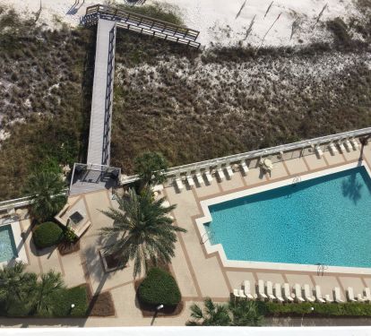 Oceanfront pool and kiddie pool plus boardwalk with stairs and ramp to beach