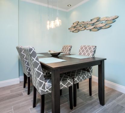 There is a dining table with four seats in the dining room. 
