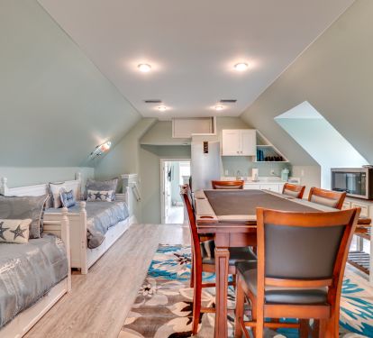 Gaming table, day beds and Kitchenette on second floor.