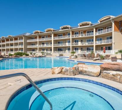 Expansive pool deck with a graduated pool entrance for little ones.