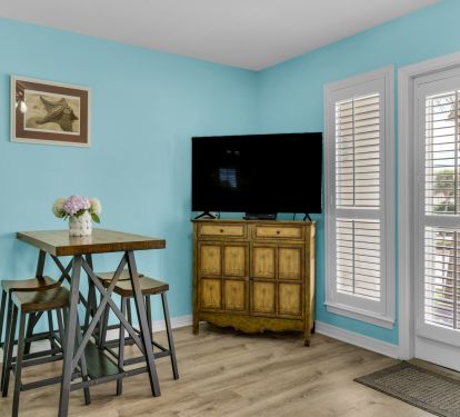 TV with cable and games and videos in cabinet