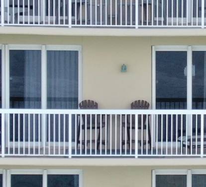 25-foot-long balcony. 2 high top and 2 regular chairs and a chaise.