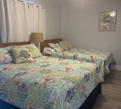 The front bedroom offers two queen beds.
