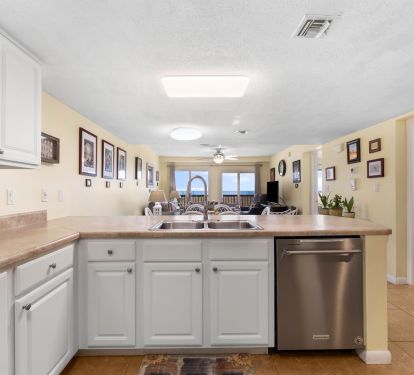 Kitchen looking through dining room and living room toward the Gulf of Mexico.