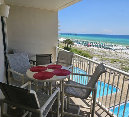 Large balcony with 2 dining tables, chaise lounge, and gorgeous views