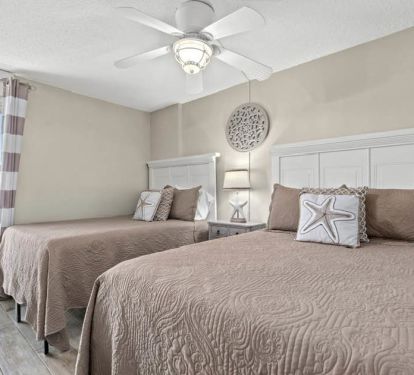2nd bedroom (smart tv on the wall in front of beds)