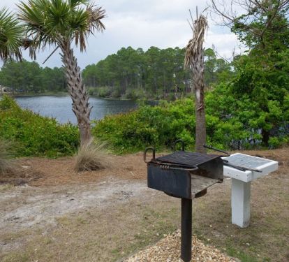 Quiet and family friendly Beachside Villas offers charcoal grills and lake views