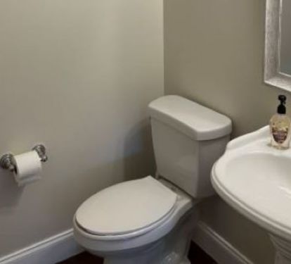 First floor half bath off back hall for added convenience