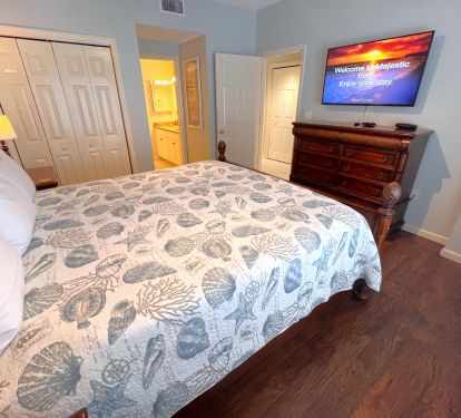 Master bedroom feautures king size bed and large flat screen television.