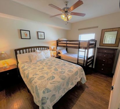 Guest bedroom sleeps up to four in a queen bed and juvenile bunk beds. 
