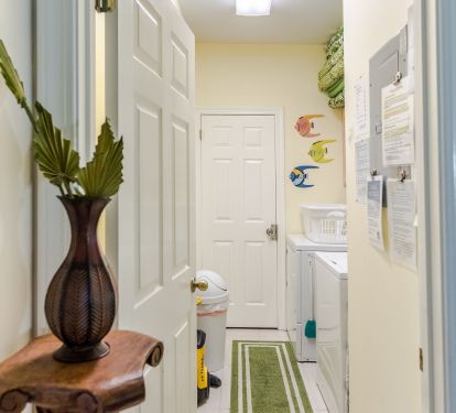 First floor full size laundry room, newer washer dryer, deep sink, iron w/board
