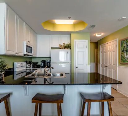 Kitchen with 3 stools. Table and chairs in LR