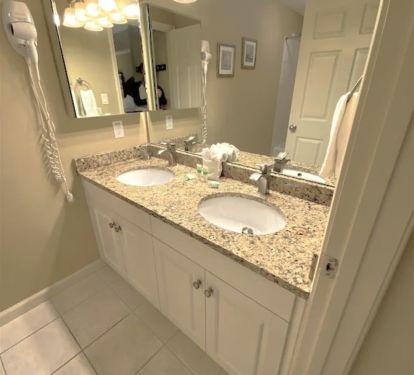 Master bathroom with double bowl sink, tub and shower.