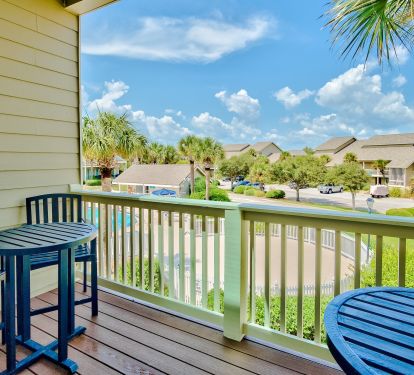 A pair of tables on deck overlooking the pool