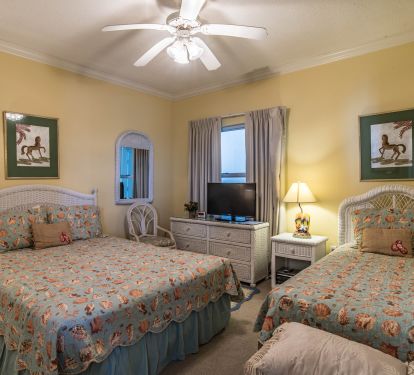 Middle Bedroom with one Queen and one Single bed.
