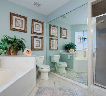 Master bath offers 2 vanities, and includes a dressing table and large mirrors.